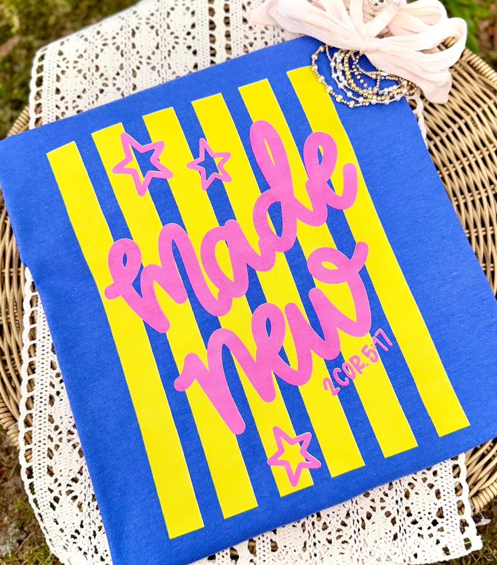 Blue and yellow sign with 'Made New' text on a woven surface